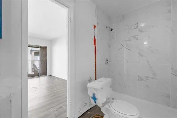 a bathroom with a toilet and a shower