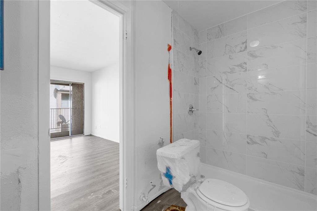4025 Billingsgate Road, Unit 2004 Orlando, FL 32839 - Photo 12 of 23 a bathroom with a toilet and a shower