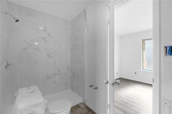 a bathroom with a toilet and a shower