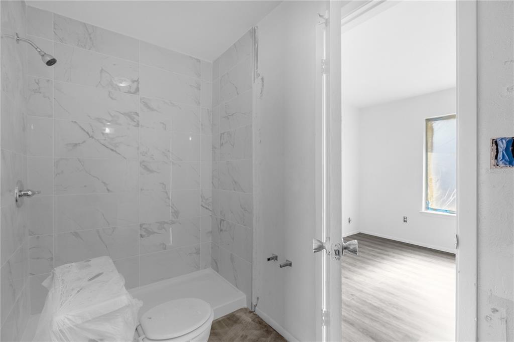 4025 Billingsgate Road, Unit 2004 Orlando, FL 32839 - Photo 15 of 23 a bathroom with a toilet and a shower