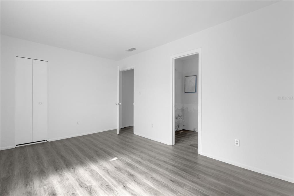 4025 Billingsgate Road, Unit 2004 Orlando, FL 32839 - Photo 16 of 23 a view of an empty room with wooden floor and closet