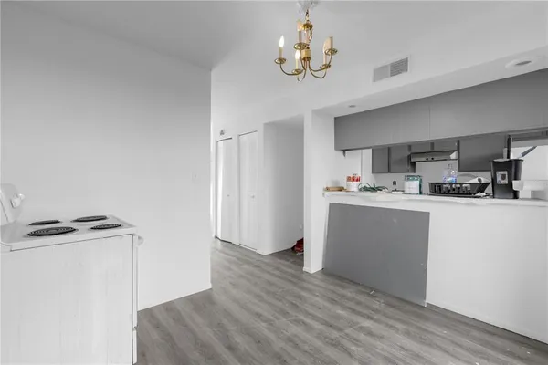 a view of kitchen with cabinets and wooden floor