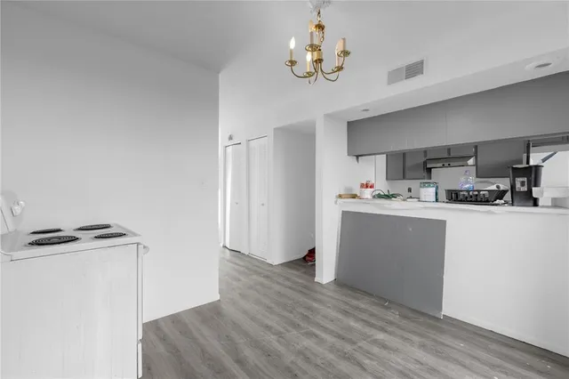 a view of kitchen with cabinets and wooden floor