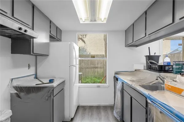 a kitchen with a sink a stove and a refrigerator