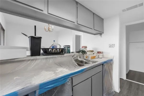 a kitchen with a sink and a refrigerator