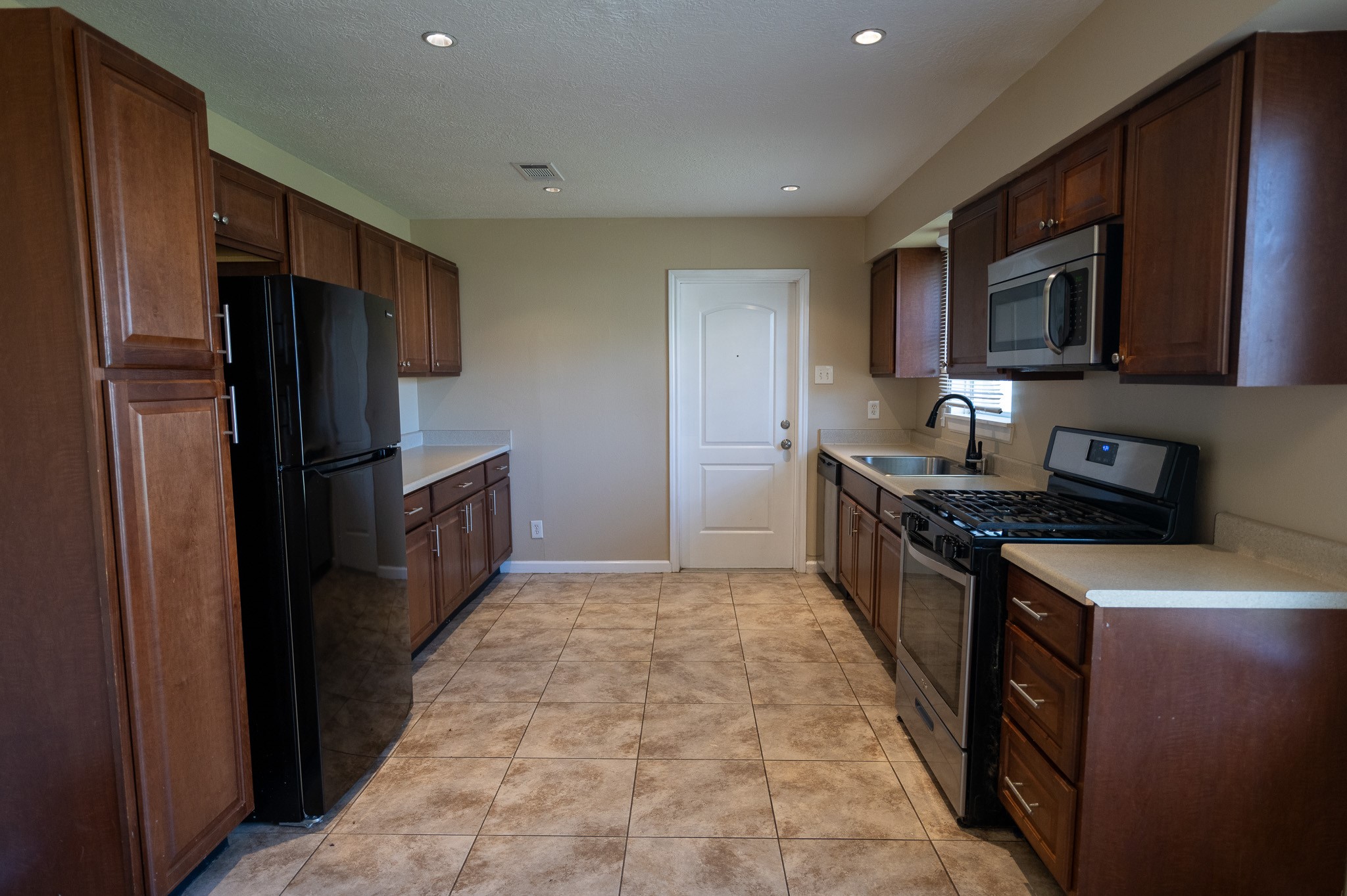 2304 Cedar Bayou Road Baytown, TX 77520 - Photo 5 of 14 a kitchen with stainless steel appliances granite countertop a refrigerator stove and microwave