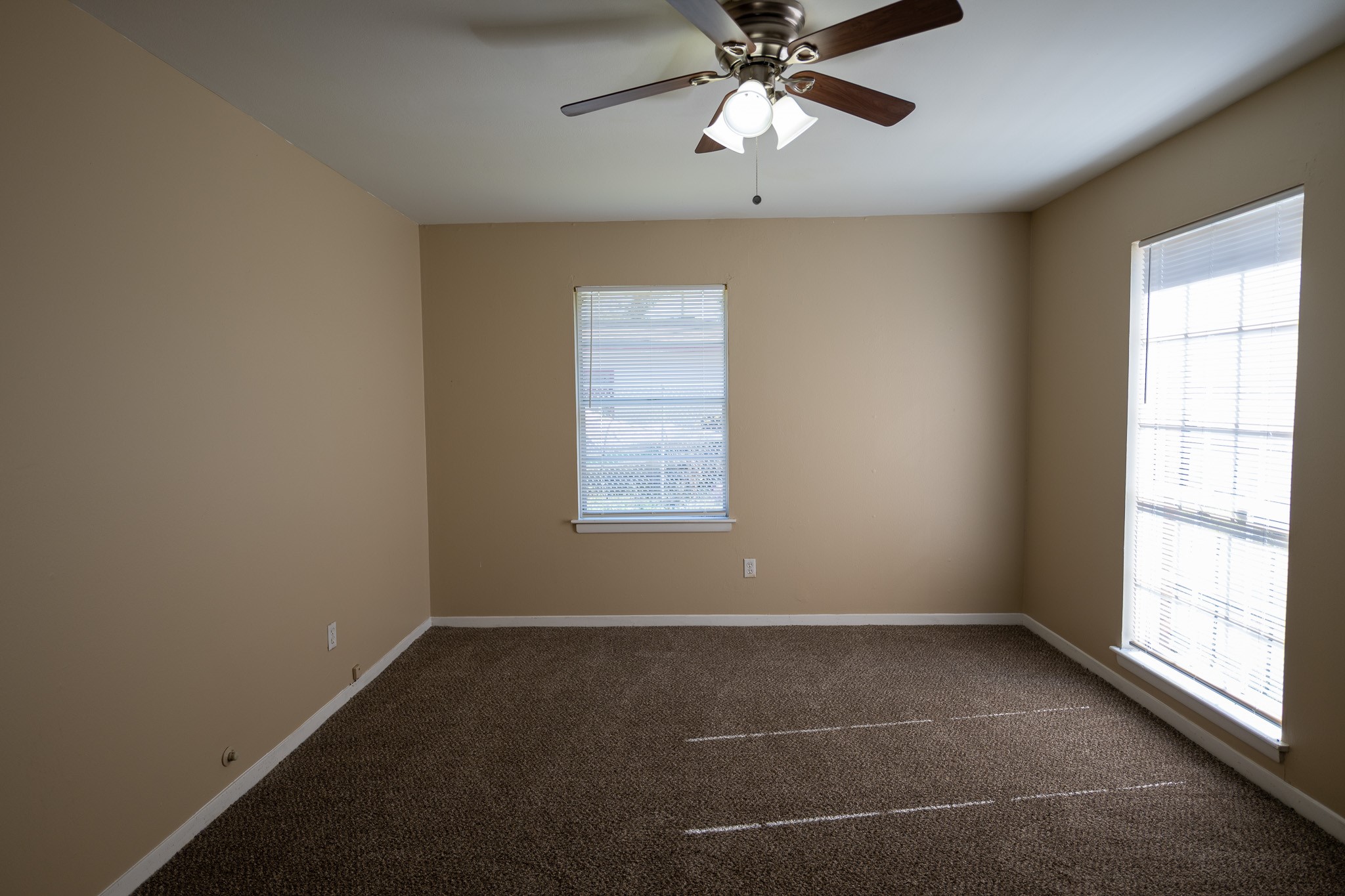 2304 Cedar Bayou Road Baytown, TX 77520 - Photo 9 of 14 an empty room with a window and a fan