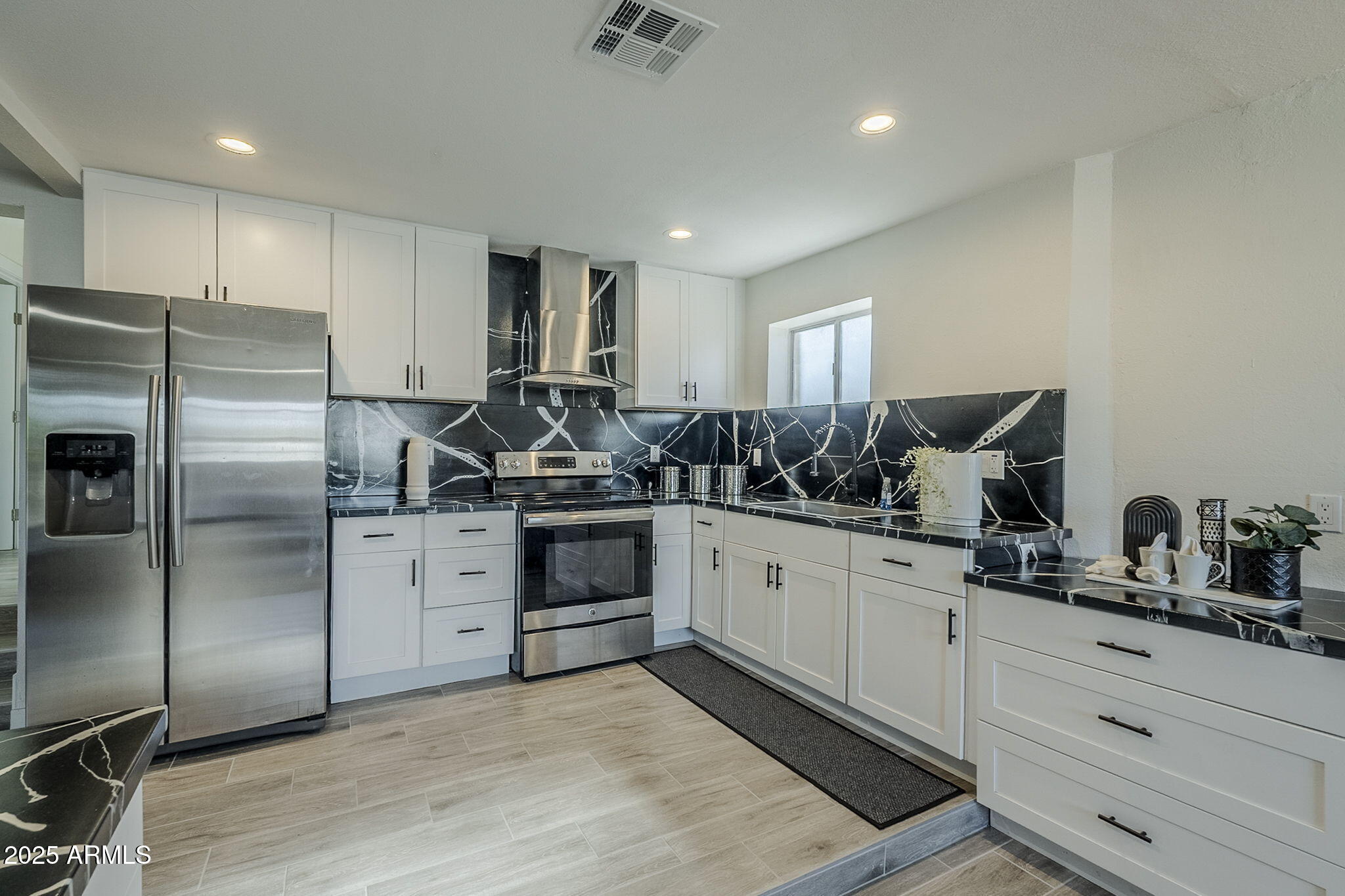 8644 West Mountain View Road Peoria, AZ 85345 - Photo 11 of 35 a kitchen with stainless steel appliances granite countertop a sink and cabinets