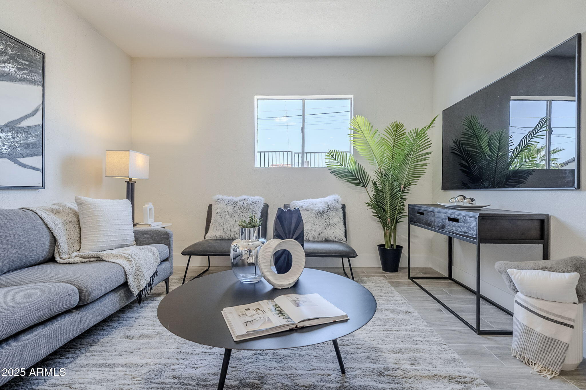8644 West Mountain View Road Peoria, AZ 85345 - Photo 13 of 35 a living room with furniture a flat screen tv and a potted plant