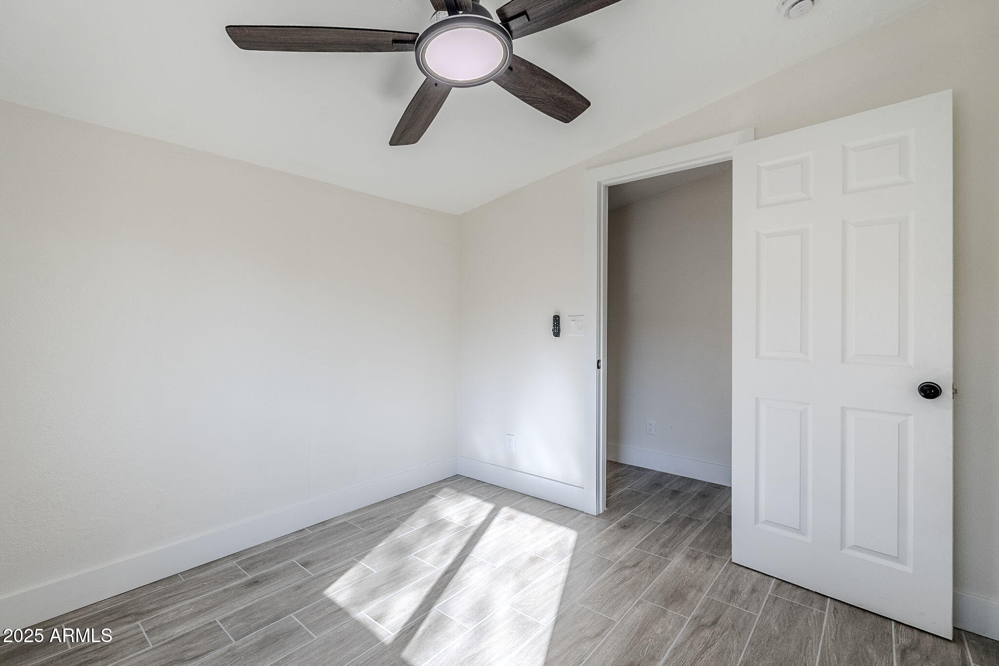 8644 West Mountain View Road Peoria, AZ 85345 - Photo 15 of 35 a view of empty room with wooden floor
