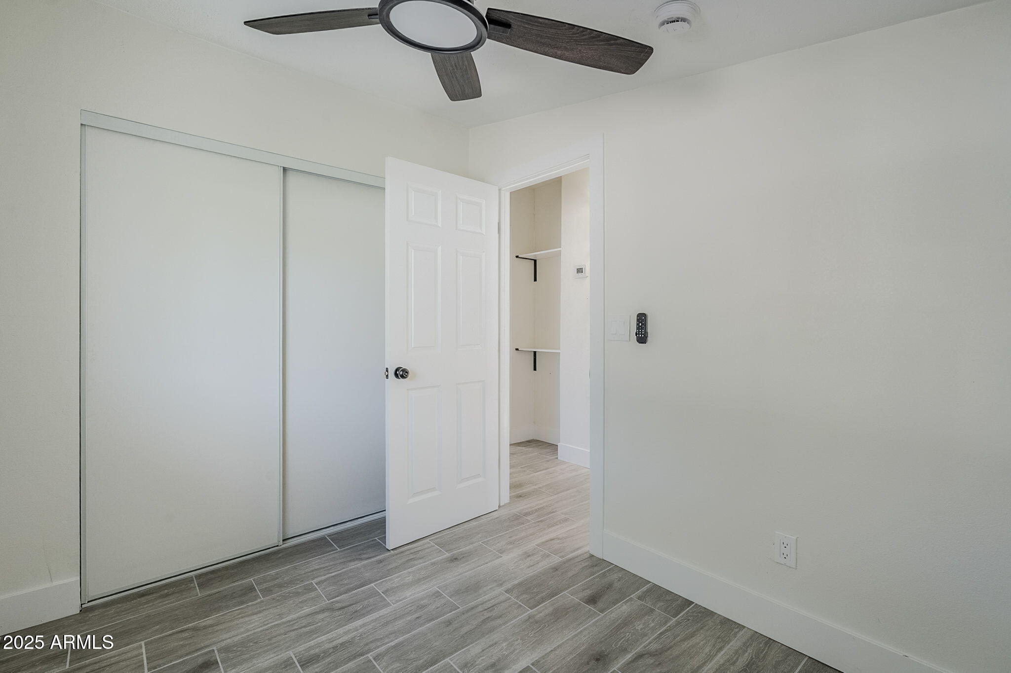 8644 West Mountain View Road Peoria, AZ 85345 - Photo 17 of 35 a view of an empty room with wooden floor