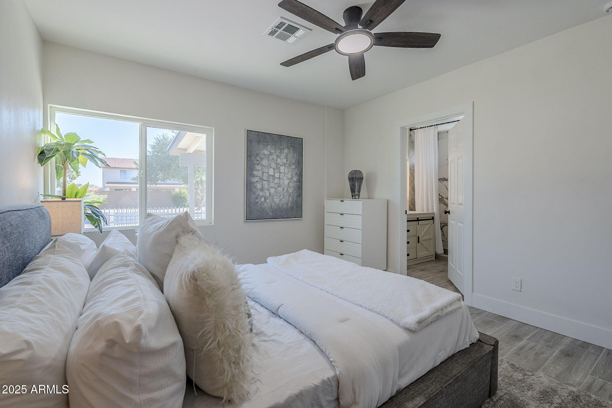 8644 West Mountain View Road Peoria, AZ 85345 - Photo 19 of 35 a bedroom with a bed chandelier and a window