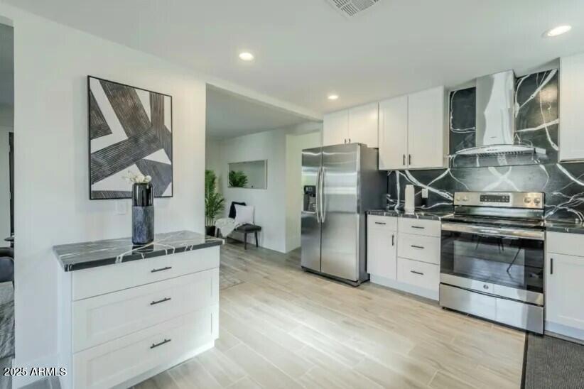 8644 West Mountain View Road Peoria, AZ 85345 - Photo 2 of 35 a kitchen with refrigerator cabinets and stainless steel appliances