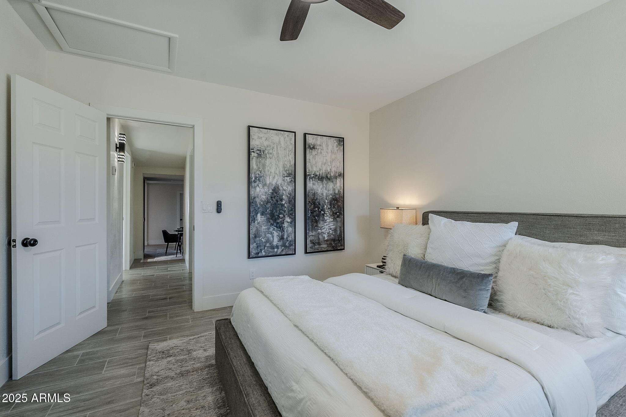 8644 West Mountain View Road Peoria, AZ 85345 - Photo 22 of 35 a bedroom with a bed and a chandelier