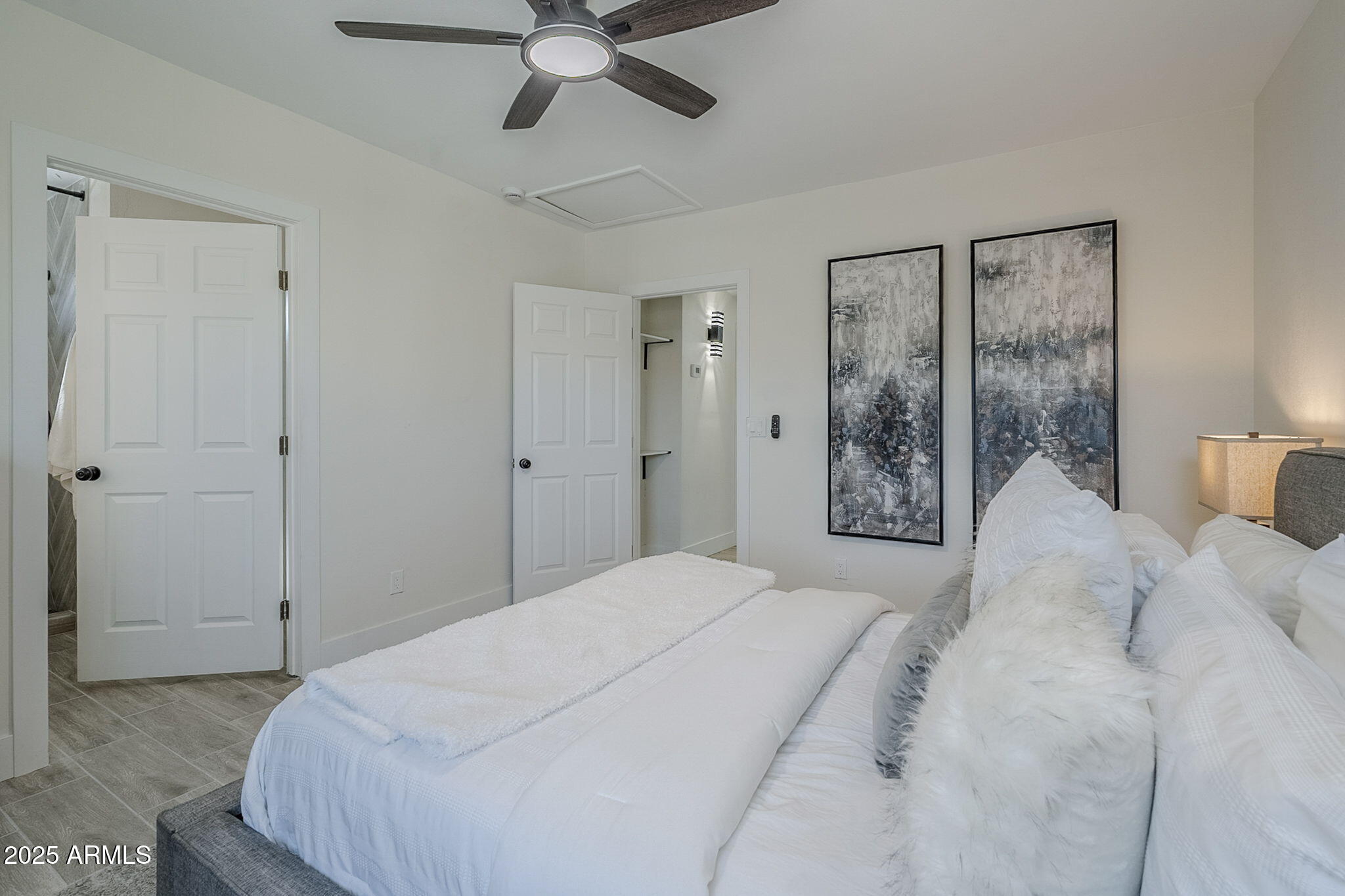 8644 West Mountain View Road Peoria, AZ 85345 - Photo 23 of 35 a bedroom with a large bed and a chandelier