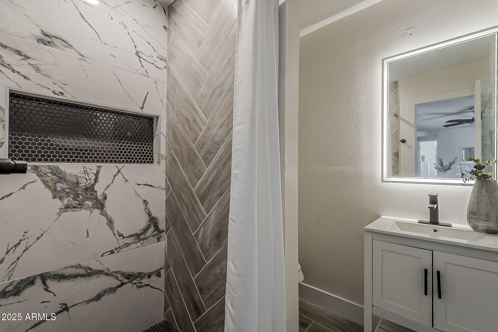 8644 West Mountain View Road Peoria, AZ 85345 - Photo 26 of 35 a bathroom with a sink and mirror