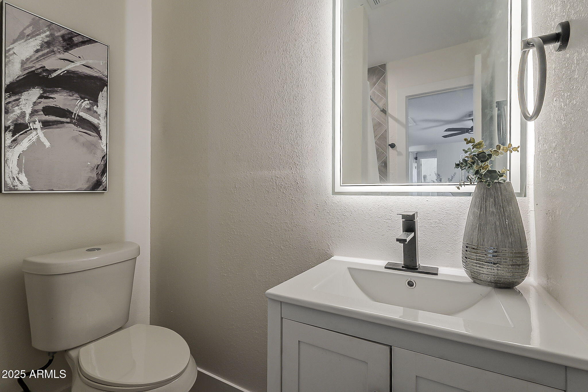8644 West Mountain View Road Peoria, AZ 85345 - Photo 28 of 35 a bathroom with a sink a toilet and mirror