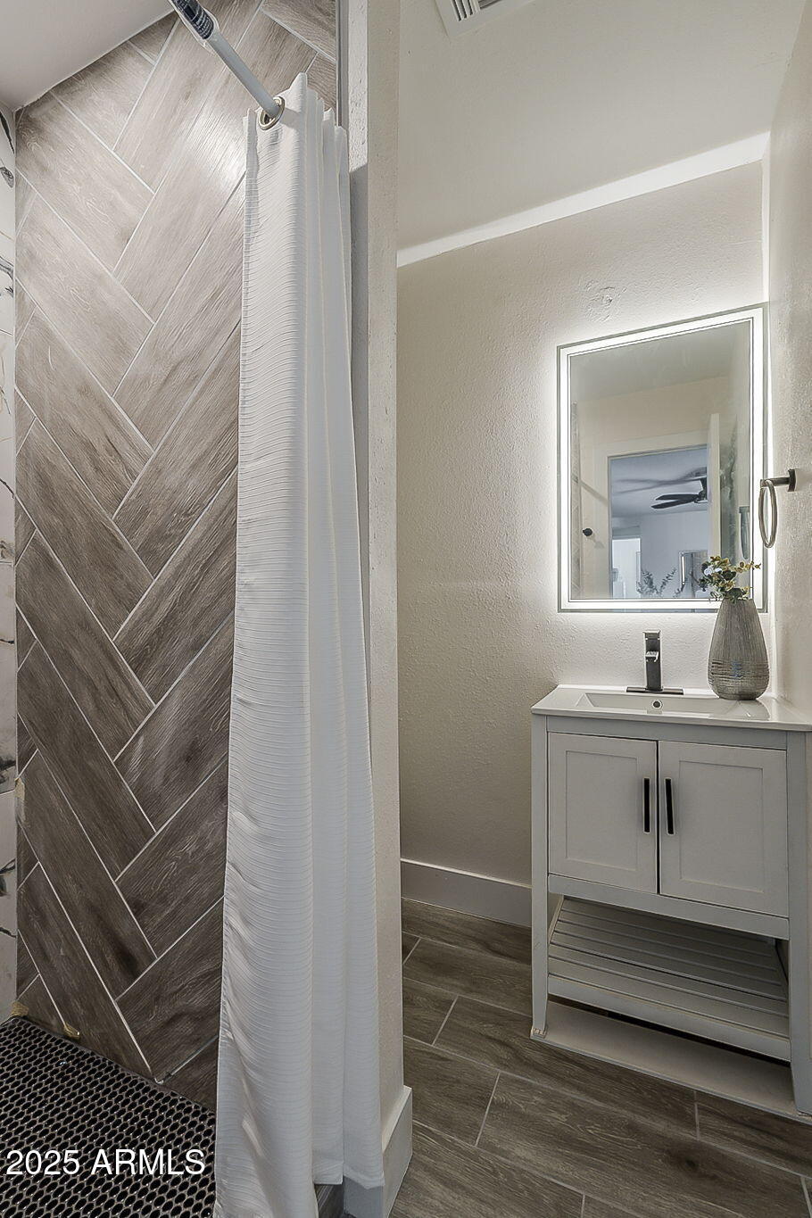 8644 West Mountain View Road Peoria, AZ 85345 - Photo 29 of 35 a bathroom with a sink and a mirror