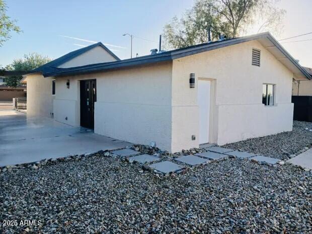 8644 West Mountain View Road Peoria, AZ 85345 - Photo 32 of 35 a front view of a house with a garden