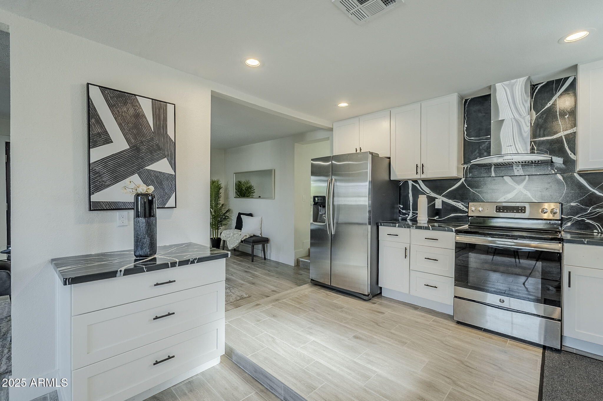8644 West Mountain View Road Peoria, AZ 85345 - Photo 10 of 35 a kitchen with refrigerator cabinets and stainless steel appliances