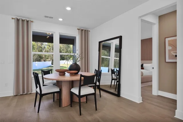 a dining room with furniture and window