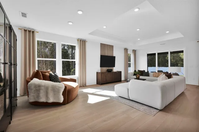 a living room with furniture window and flat screen tv