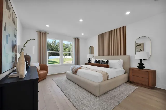 a bedroom with a large bed and a window