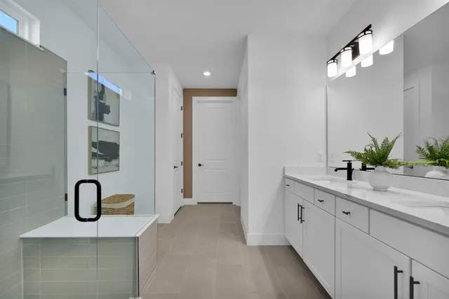 a spacious bathroom with a sink and a mirror
