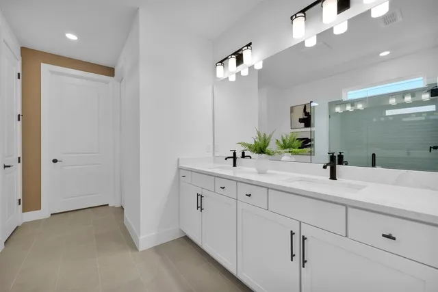 a bathroom with a double vanity sink and a mirror