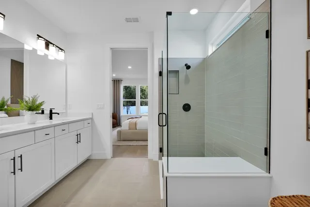 a bathroom with a double vanity sink toilet and shower