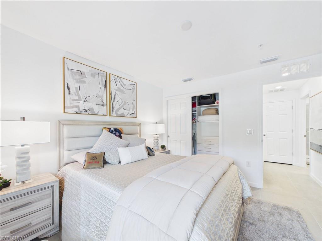 5683 Mayflower Way, Unit 908 Ave Maria, FL 34142 - Photo 16 of 37 Bedroom with a closet and light tile patterned floors