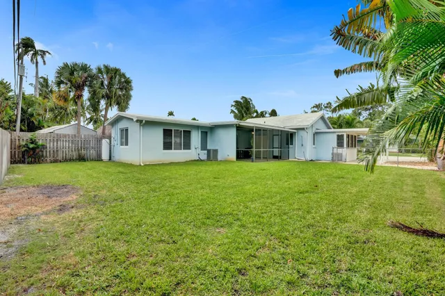 a view of a room with wooden floor a ceiling fan and a window