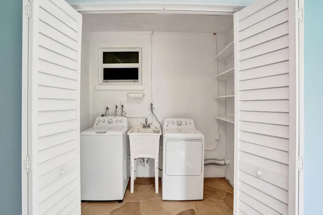 a utility room with a sink washer and dryer