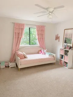 a bedroom with furniture and a window