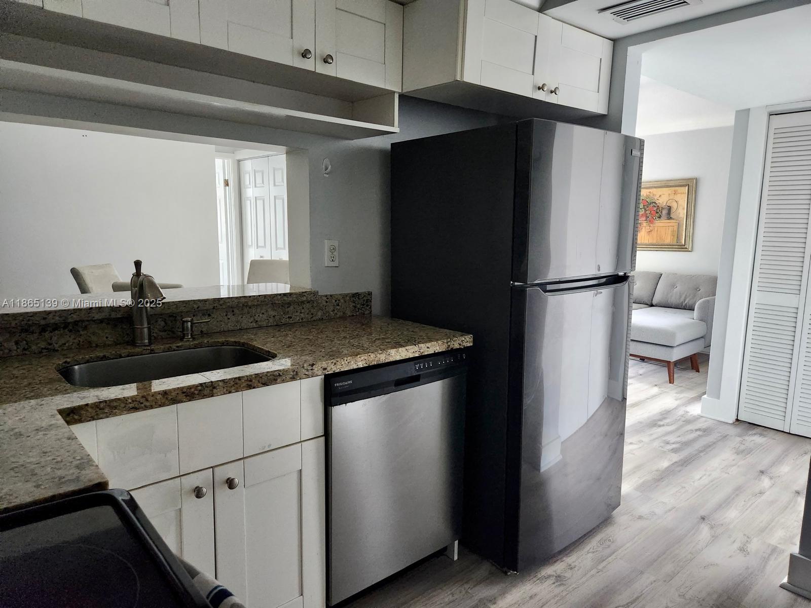 11790 Southwest 18th Street, Unit 2183 Miami, FL 33175 - Photo 11 of 28 a kitchen with a refrigerator and a sink