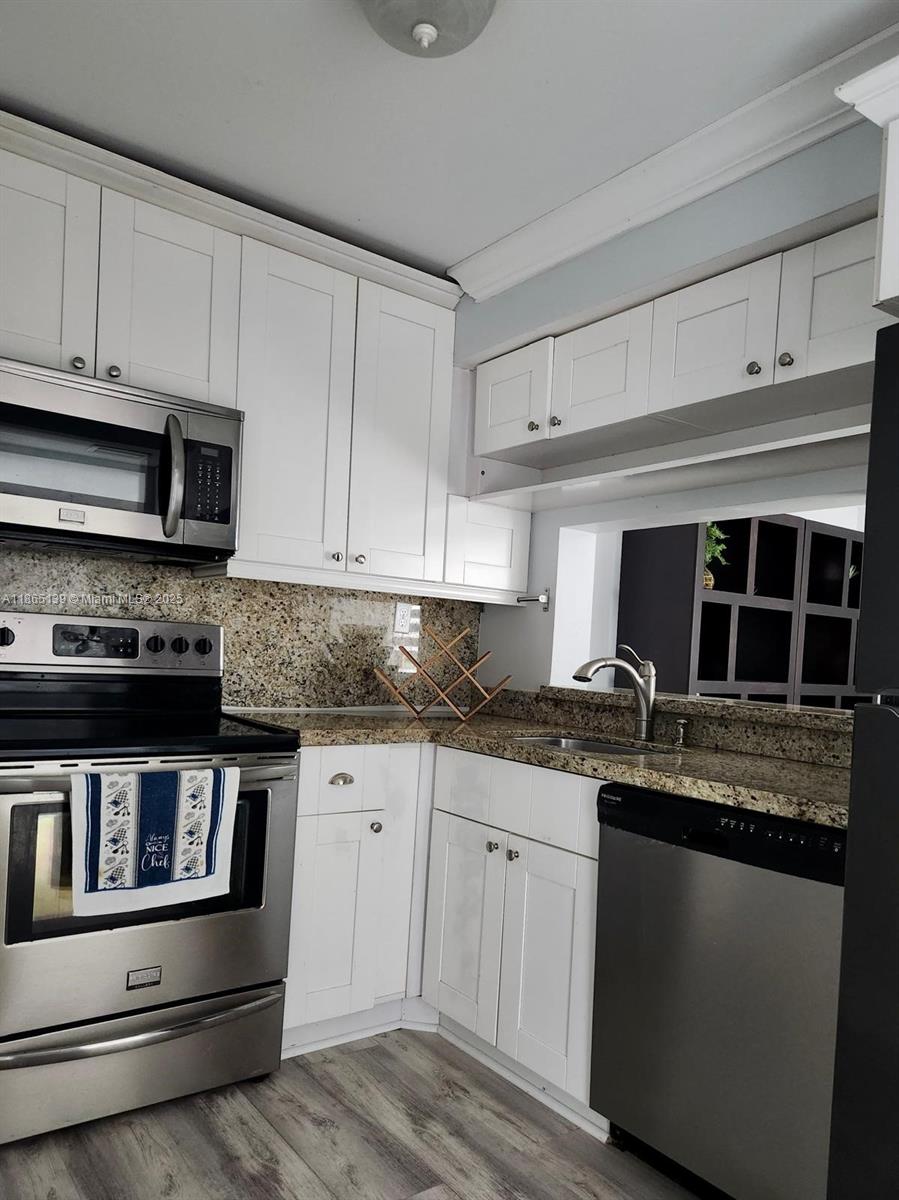 11790 Southwest 18th Street, Unit 2183 Miami, FL 33175 - Photo 13 of 28 a kitchen with granite countertop a sink and cabinets