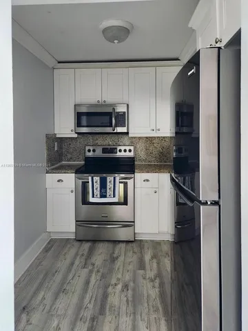 a view of a hallway and interior of a house and wooden floor