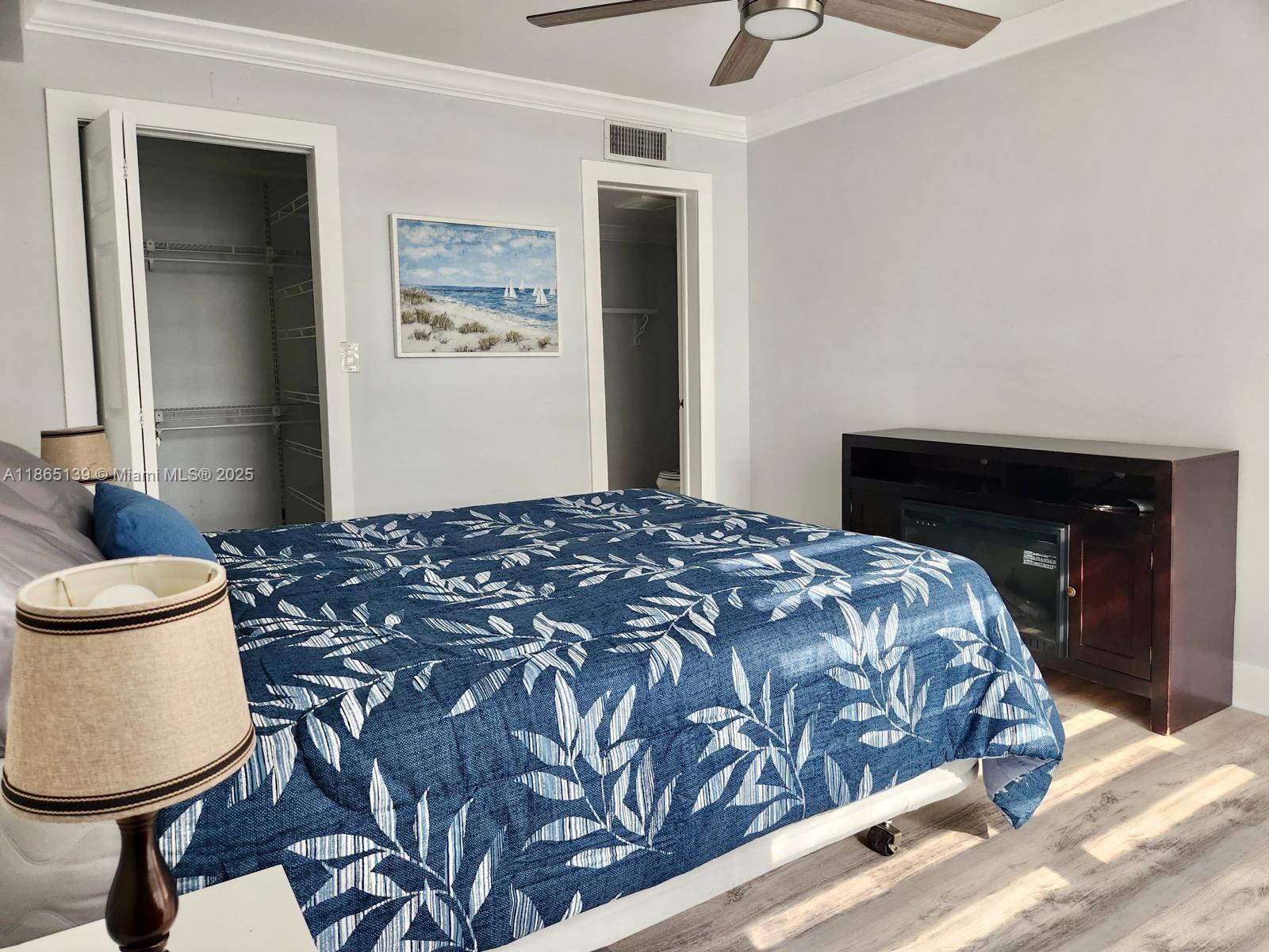 11790 Southwest 18th Street, Unit 2183 Miami, FL 33175 - Photo 19 of 28 a bedroom with a bed and painting on the wall