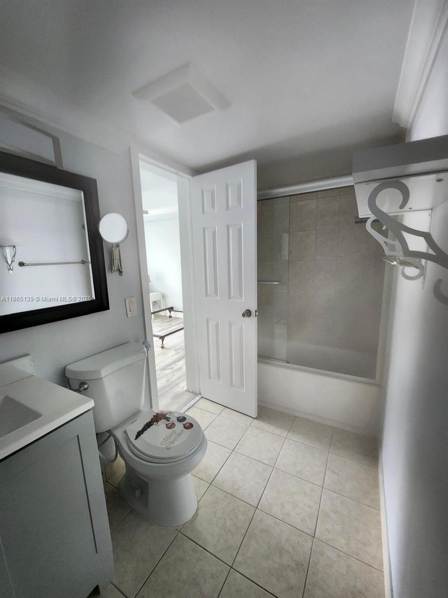 11790 Southwest 18th Street, Unit 2183 Miami, FL 33175 - Photo 21 of 28 a bathroom with a toilet a sink and shower