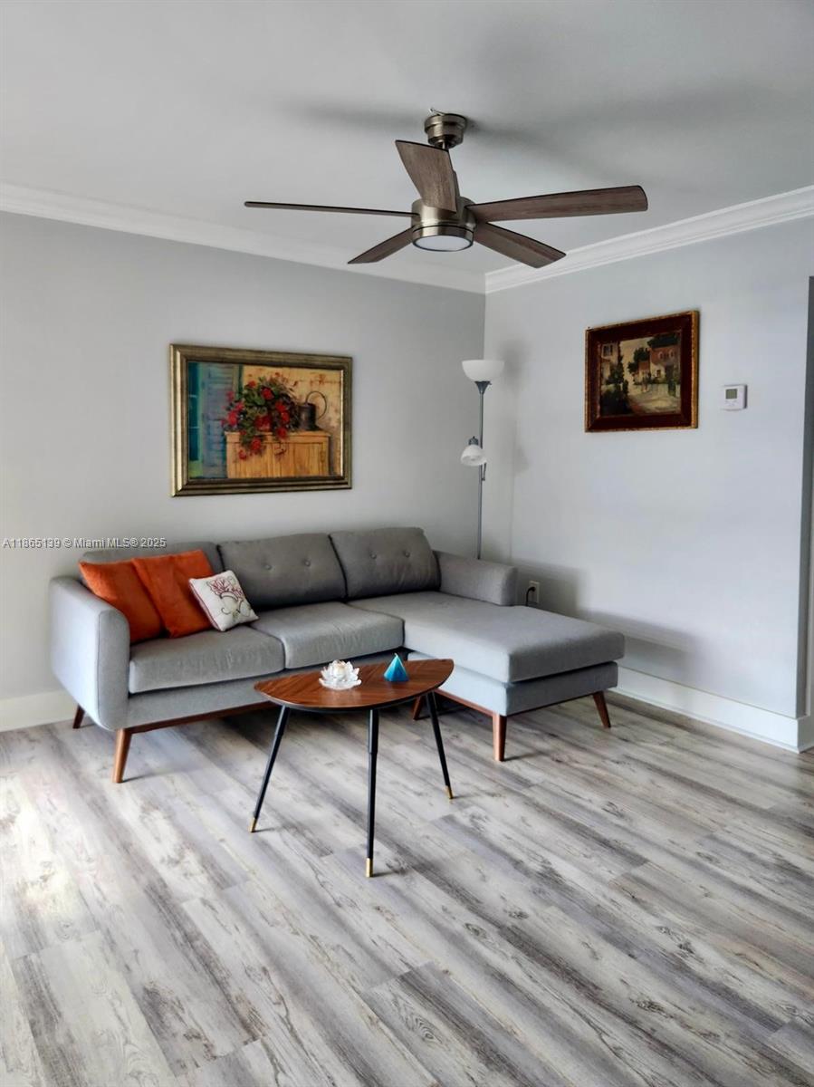 11790 Southwest 18th Street, Unit 2183 Miami, FL 33175 - Photo 8 of 28 a living room with furniture and a wooden floor