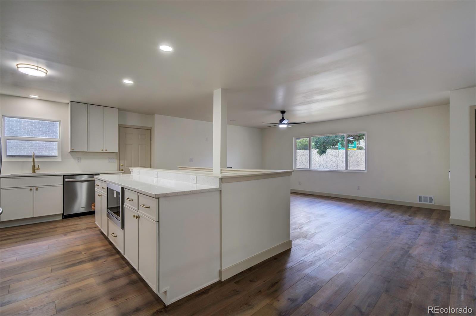 1815 South Monroe Street Denver, CO 80210 - Photo 13 of 37 a kitchen with granite countertop a sink and a stove top oven