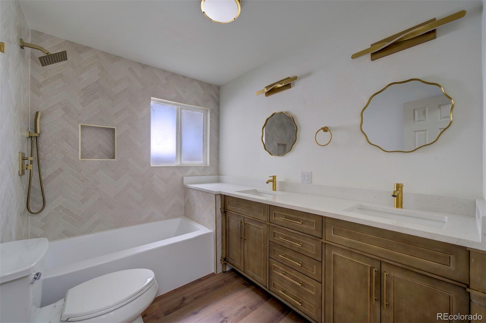 1815 South Monroe Street Denver, CO 80210 - Photo 15 of 37 a bathroom with a granite countertop sink mirror toilet and bathtub