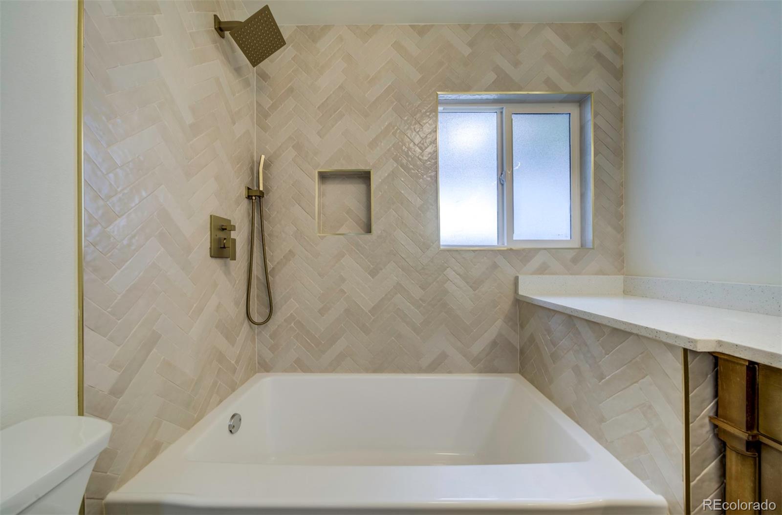 1815 South Monroe Street Denver, CO 80210 - Photo 16 of 37 a bathroom with a bathtub