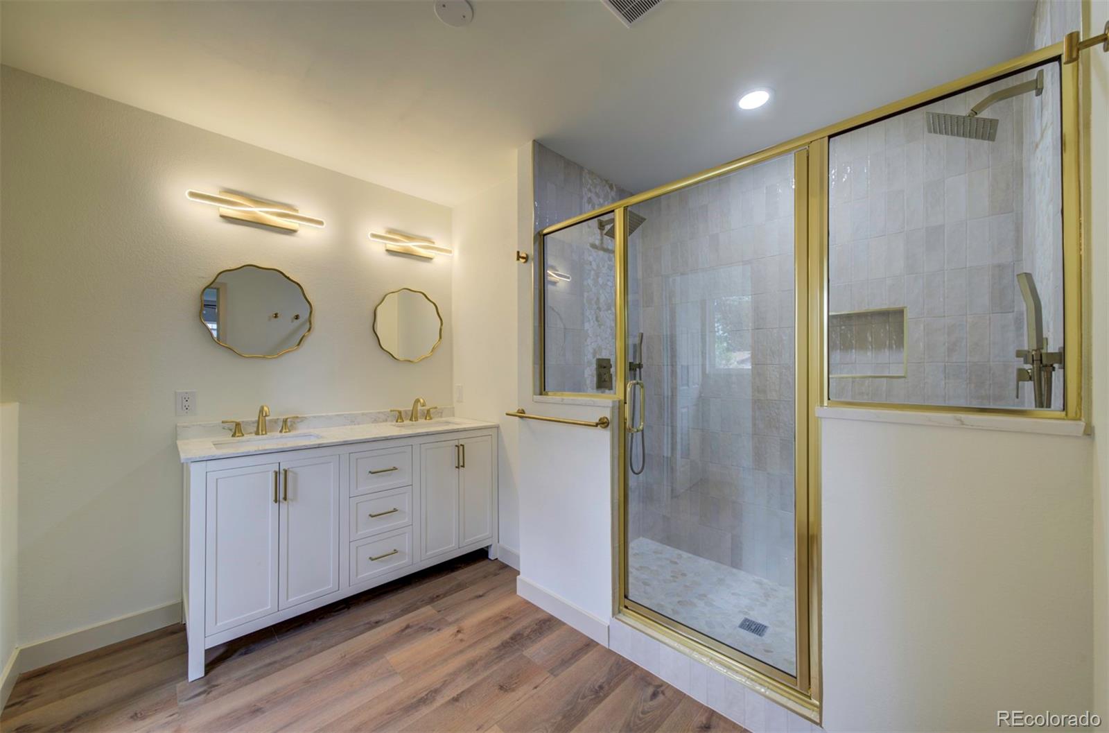 1815 South Monroe Street Denver, CO 80210 - Photo 17 of 37 a bathroom with a double vanity sink mirror and shower