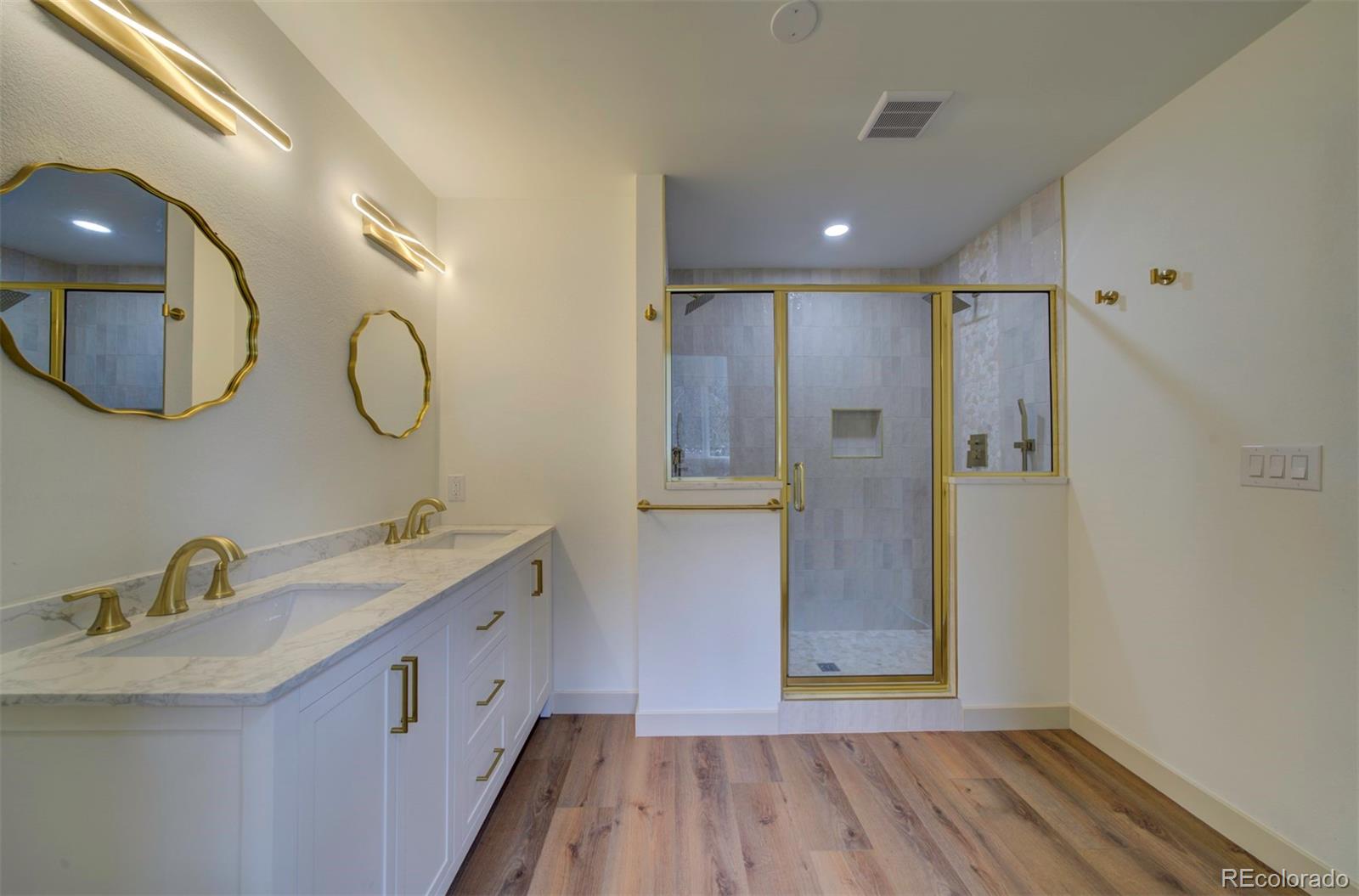 1815 South Monroe Street Denver, CO 80210 - Photo 19 of 37 a bathroom with a double vanity sink mirror and shower