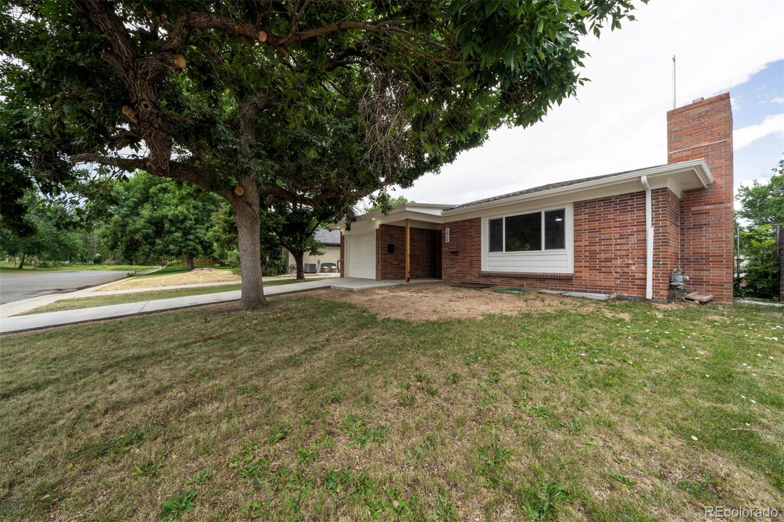1815 South Monroe Street Denver, CO 80210 - Photo 2 of 37 a front view of a house with garden