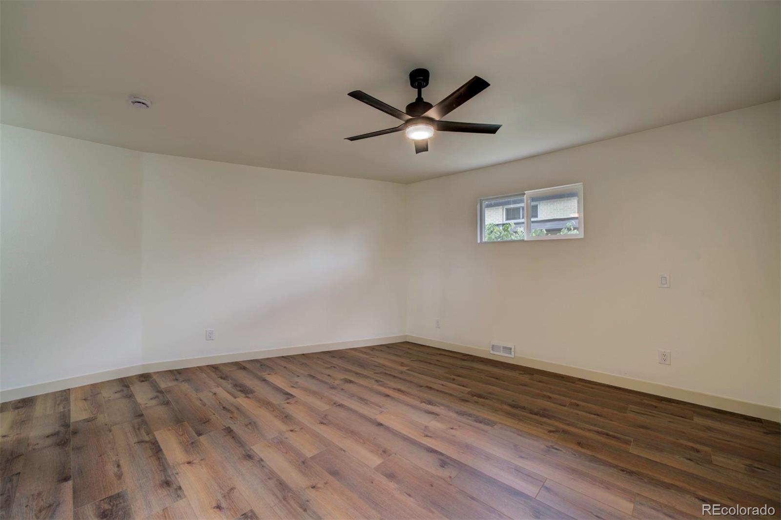 1815 South Monroe Street Denver, CO 80210 - Photo 23 of 37 a view of empty room with wooden floor