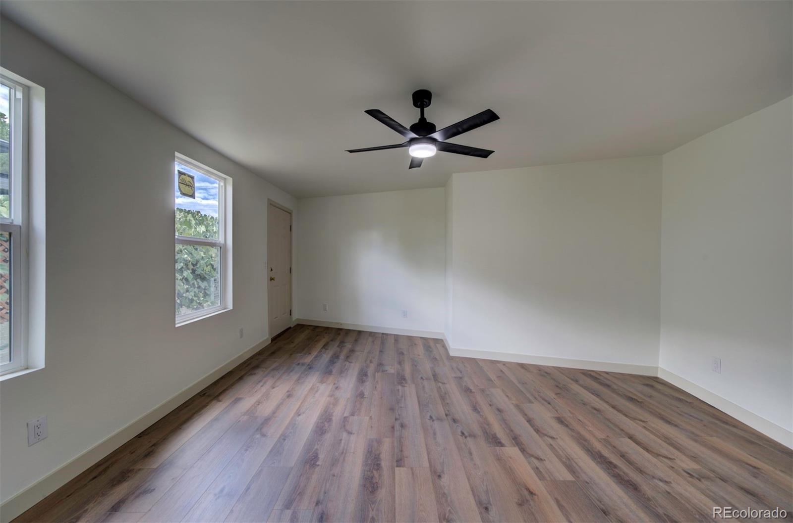 1815 South Monroe Street Denver, CO 80210 - Photo 29 of 37 an empty room with wooden floor and windows