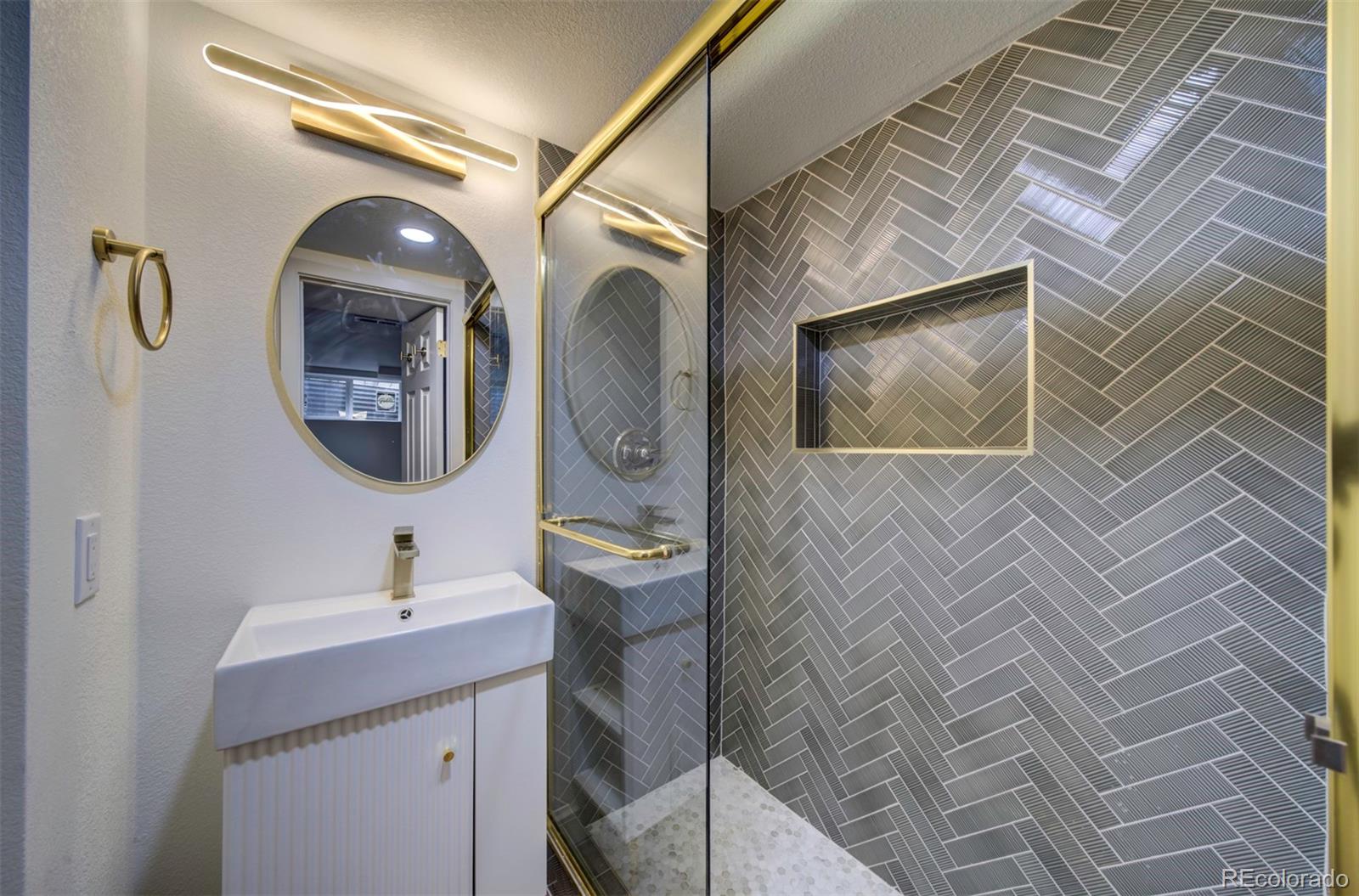 1815 South Monroe Street Denver, CO 80210 - Photo 31 of 37 a bathroom with a toilet a sink and mirror