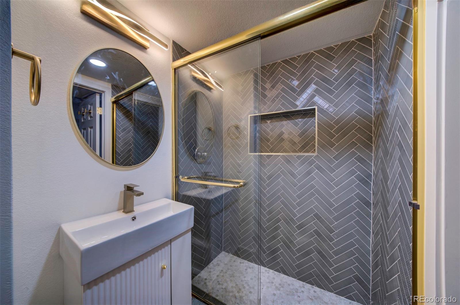 1815 South Monroe Street Denver, CO 80210 - Photo 32 of 37 a bathroom with a sink and mirror with toilet